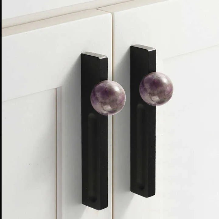 The Mantara C-0027 Calyx Handle is a modern crystal handle in black+purple, ideal for cabinets, wardrobes, and drawers.
