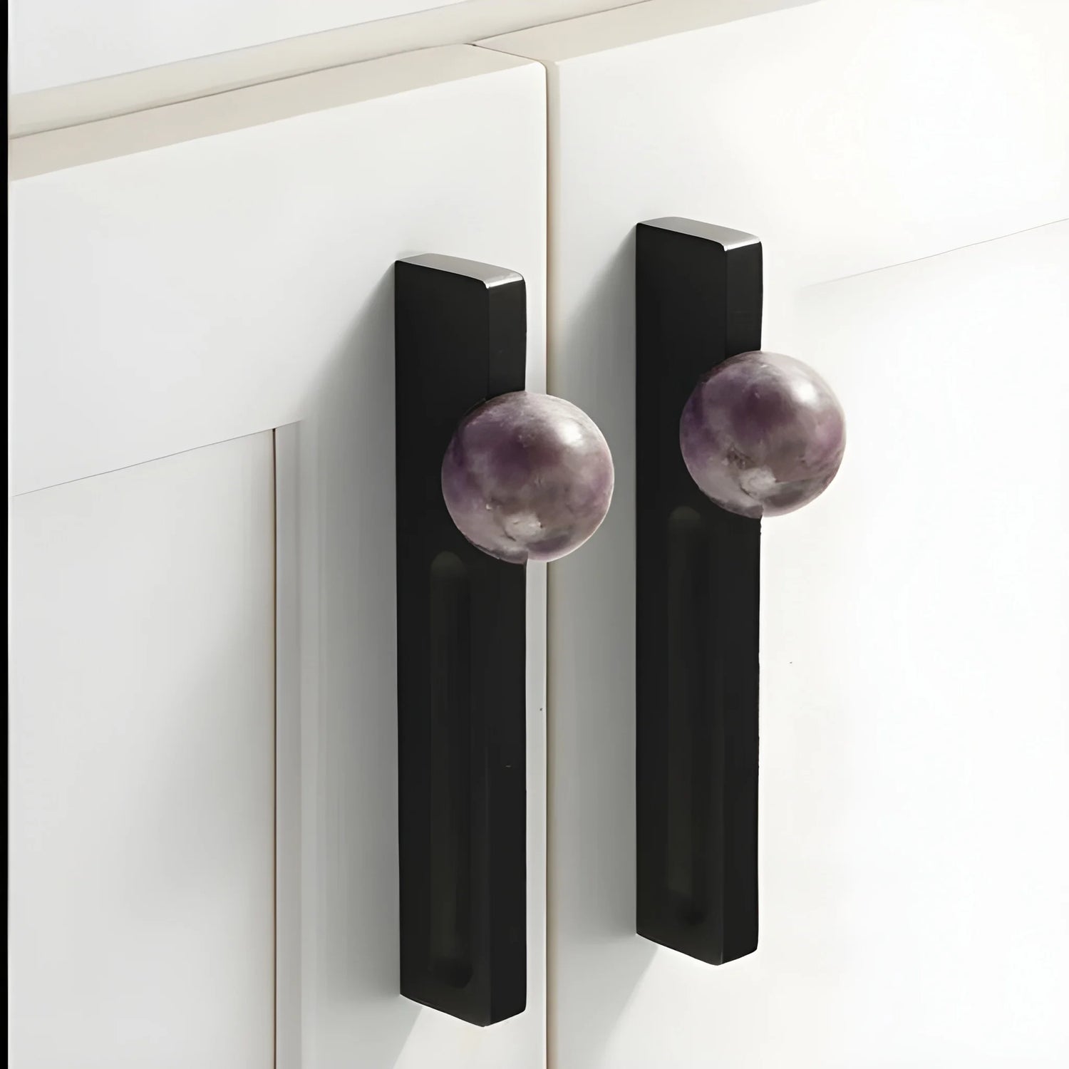 The Mantara C-0027 Calyx Handle is a modern crystal handle in black+purple, ideal for cabinets, wardrobes, and drawers.