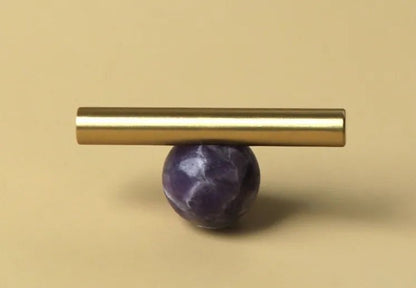 The Mantara C-0020 Chroma T-Bar is a modern crystal and brass knob in purple, ideal for drawers and cabinets.