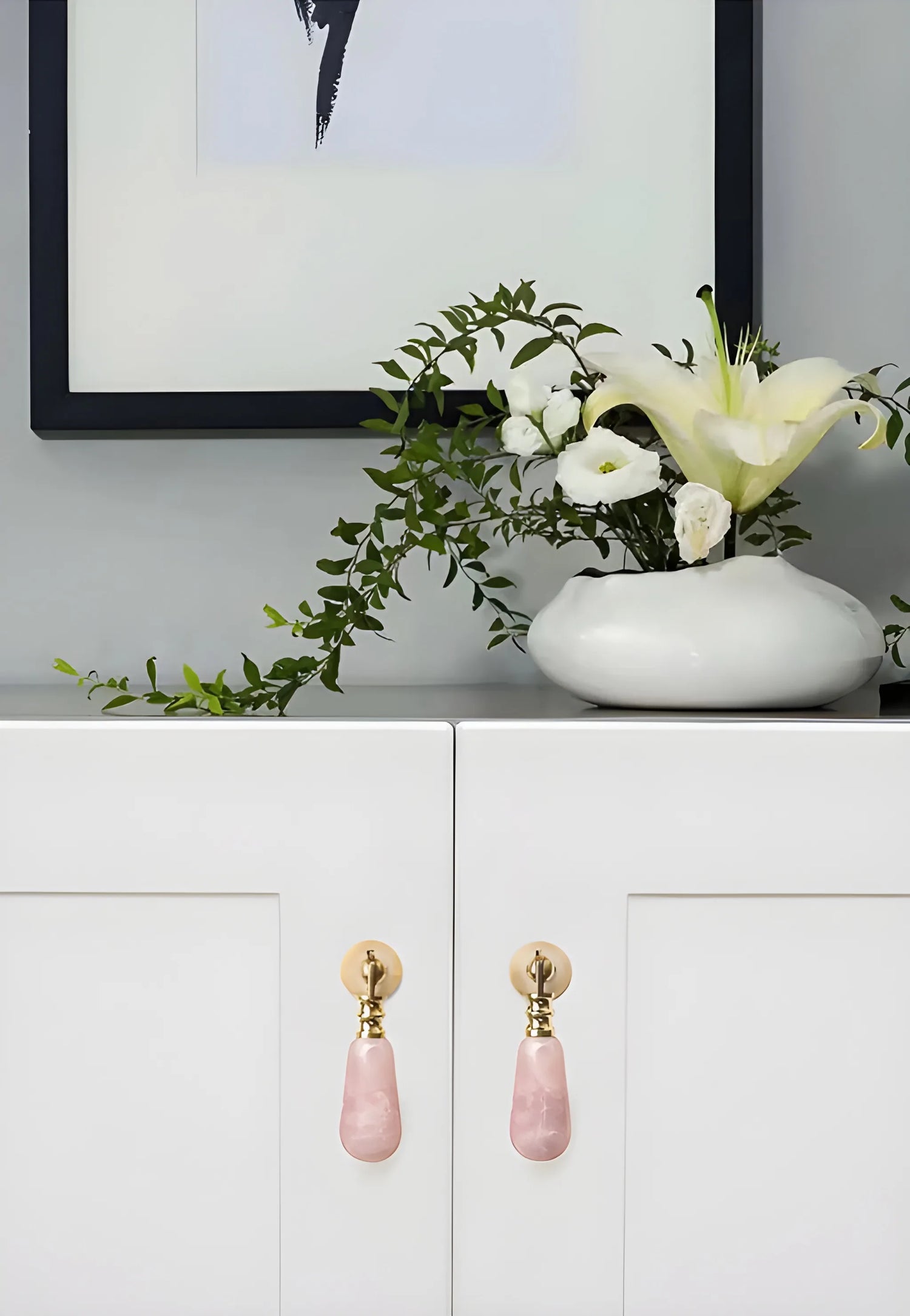 The Mantara C-0007 is a modern natural crystal + brass drop knob in pink, ideal for wardrobes and drawers.