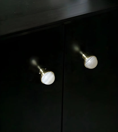 The Mantara C-0006 is a modern crystal + brass knob in white, ideal for drawers and cabinets.