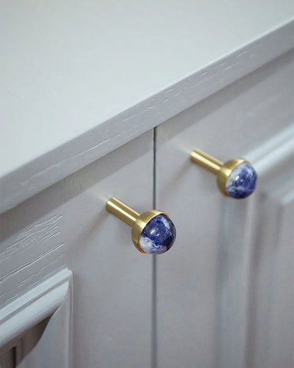The Mantara C-0006 is a modern crystal + brass knob in blue, ideal for drawers and cabinets.