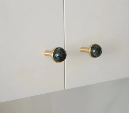 The Mantara C-0006 is a modern crystal + brass knob in black, ideal for drawers and cabinets.