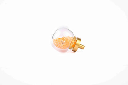 The Mantara C-0024 Frost Knob is a modern crystal and brass knob in orange, ideal for drawers, cabinets, and kitchens.