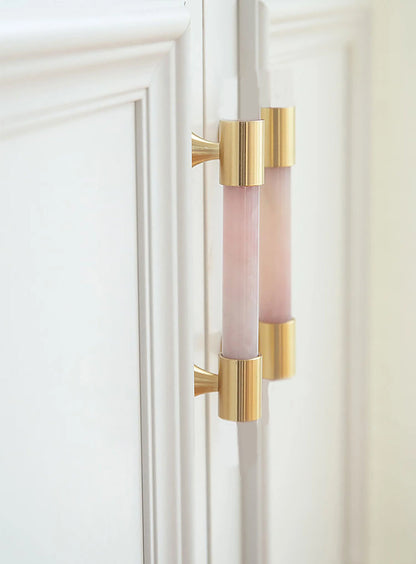 The Mantara C-0014-96 Haze Handle is a modern crystal and brass handle in pink, ideal for cabinets and wardrobes.