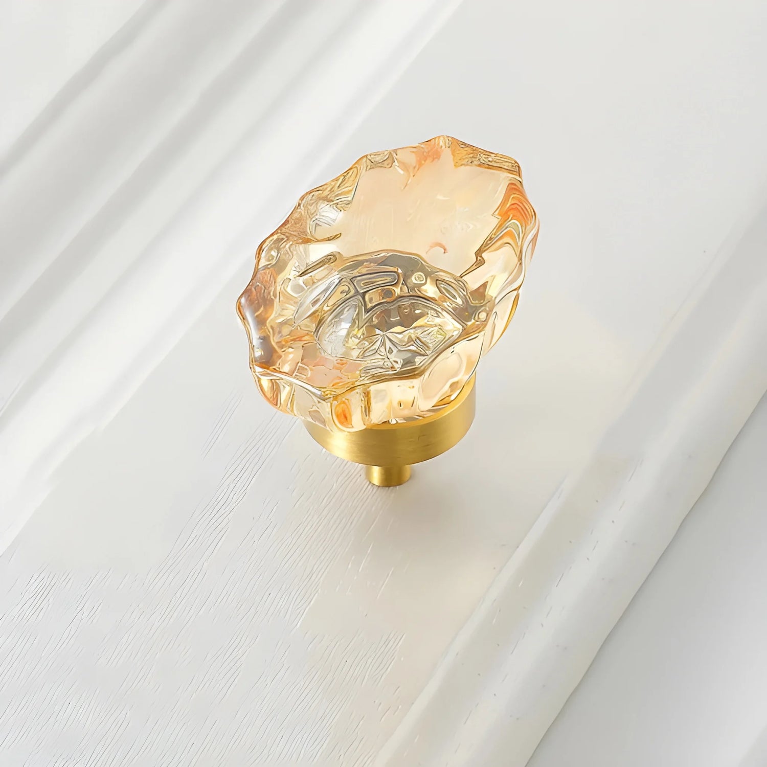The Mantara C-0009 is a modern artificial crystal + brass knob in champange/brass, ideal for kitchens and cabinets.