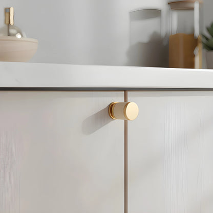 The Mantara L-0003 Tanner Knob is a modern brass and leather knob in white, perfect for cabinets and furniture.