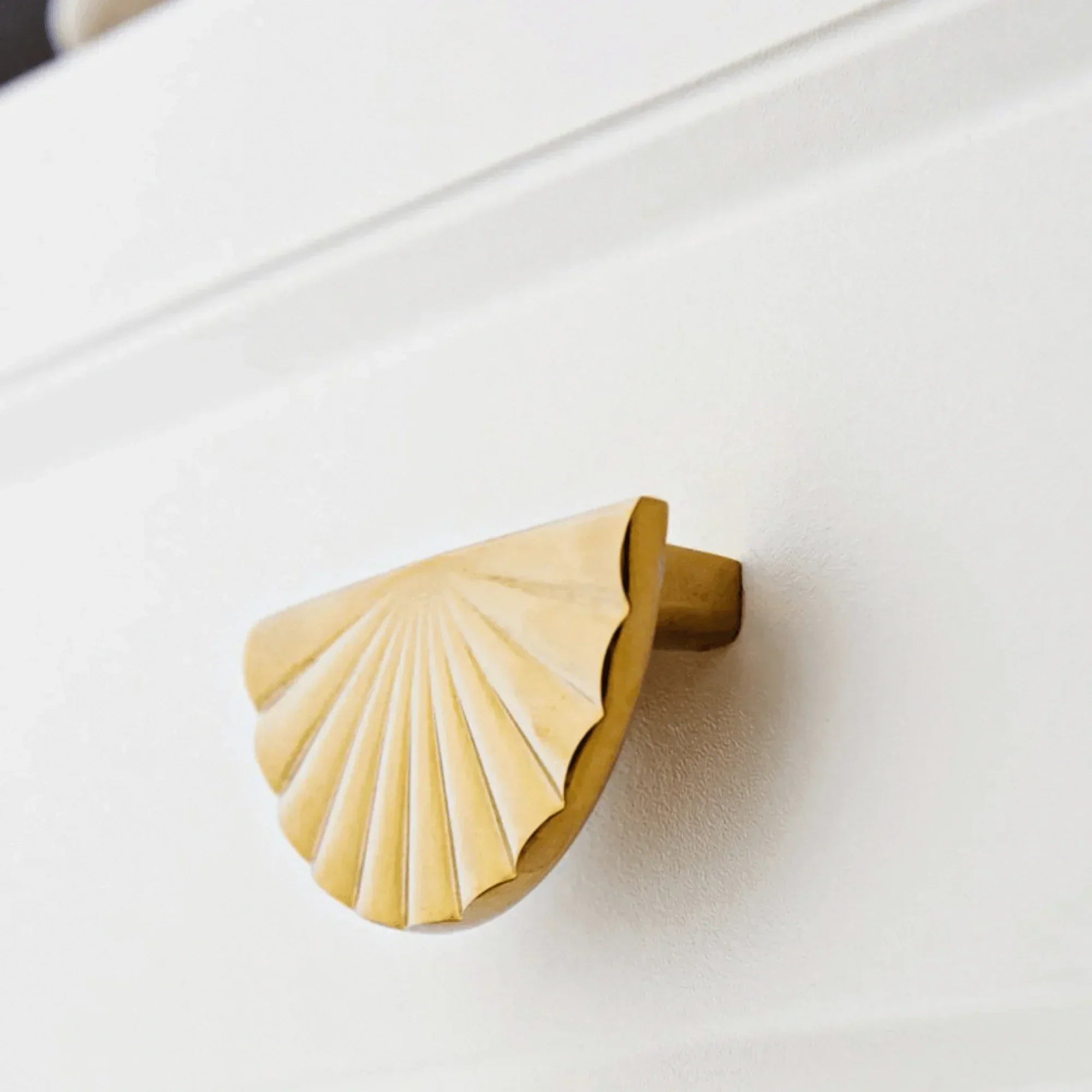 The Mantara B-0029 Kanti Knob is a modern brass handle in gold brushed finish, perfect for doors, drawers, and cabinets.