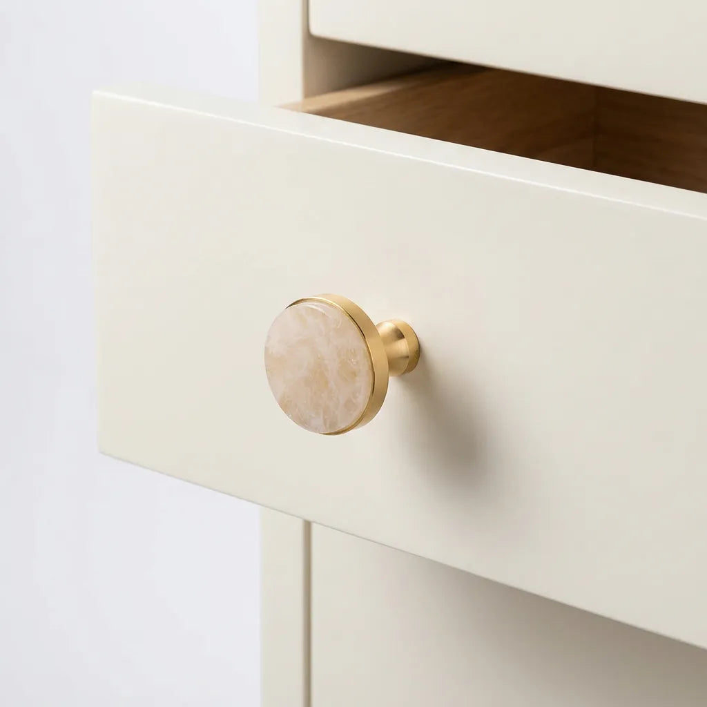 White Crystal with brass knob installed on the white opened drawer 