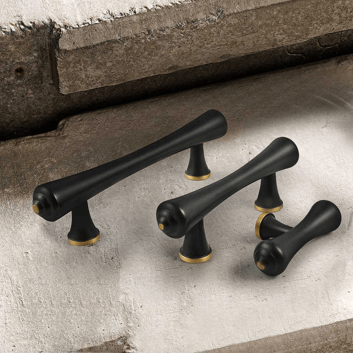Black cabinet handles mounted on a white cabinet, creating a bold contrast with modern appeal—designed by Mantara.
