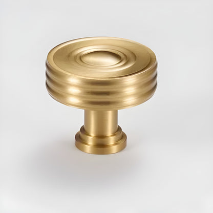The Mantara B-0121 is a modern brass knob in gold with a brushed finish, ideal for kitchen drawers and dressers.