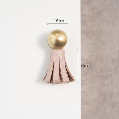 The Mantara L-0002 Maverick Drop Knob is a modern leather and brass knob in pink, ideal for kitchens and furniture.