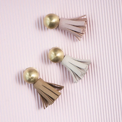 The Mantara L-0002 Maverick Drop Knob is a modern leather and brass knob in white,pink,Brown, ideal for kitchens and furniture.