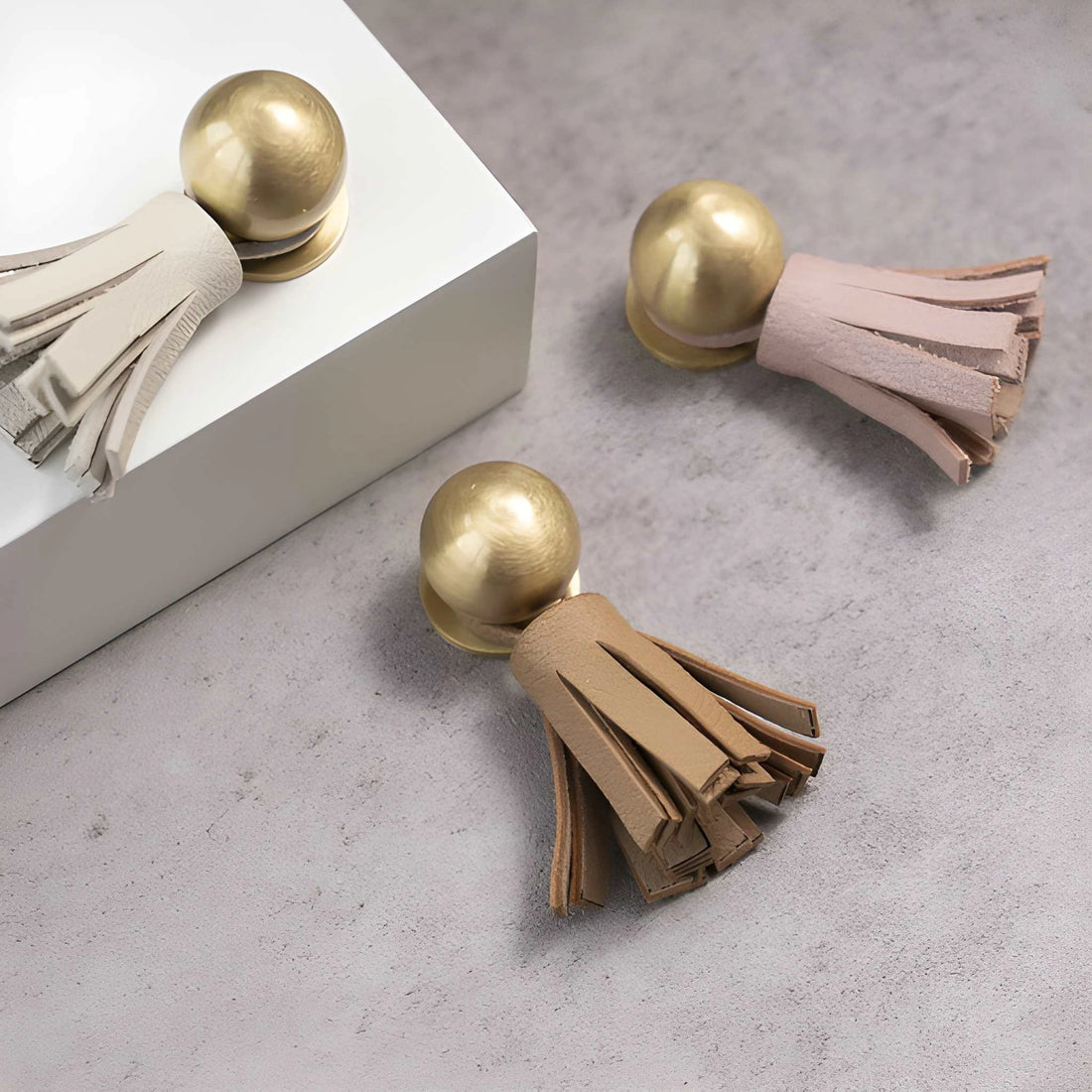The Mantara L-0002 Maverick Drop Knob is a modern leather and brass knob in white,pink,Brown, ideal for kitchens and furniture.