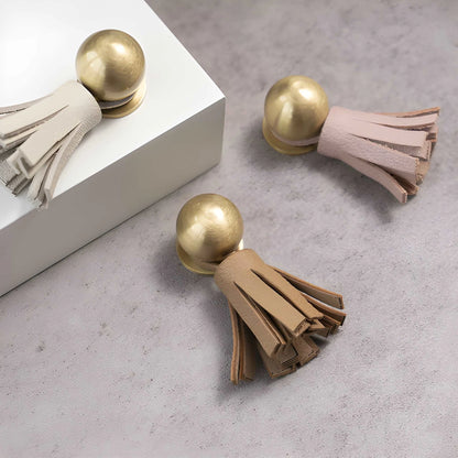 The Mantara L-0002 Maverick Drop Knob is a modern leather and brass knob in white,pink,Brown, ideal for kitchens and furniture.