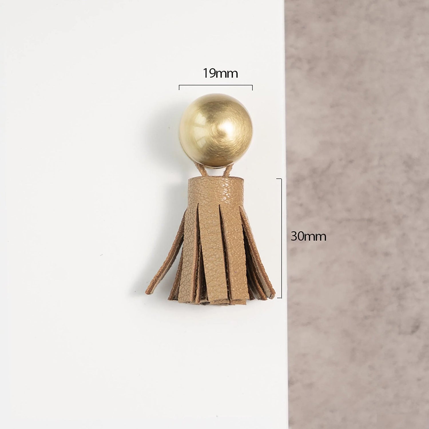 The Mantara L-0002 Maverick Drop Knob is a modern leather and brass knob in brown, ideal for kitchens and furniture.