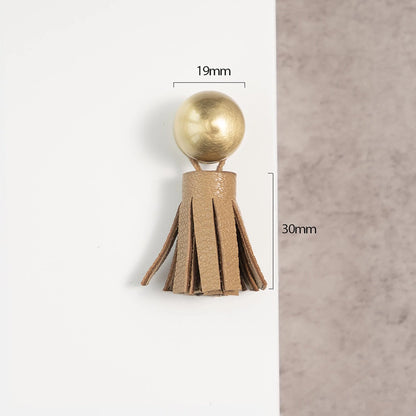 The Mantara L-0002 Maverick Drop Knob is a modern leather and brass knob in brown, ideal for kitchens and furniture.