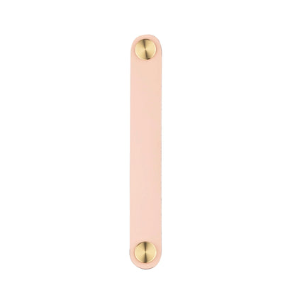 The Mantara L-0001-160 Maverick Handle is a Nordic leather and brass handle in pink, ideal for kitchens and wardrobes.
