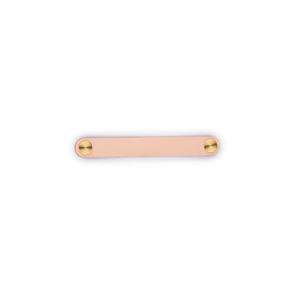 The Mantara L-0001-160 Maverick Handle is a Nordic leather and brass handle in pink, ideal for kitchens and wardrobes.