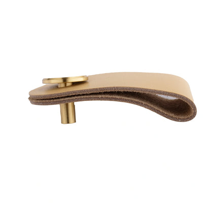 The Mantara L-0001 Maverick Pull Knob is a Nordic leather and brass knob in beige, ideal for kitchens and furniture.