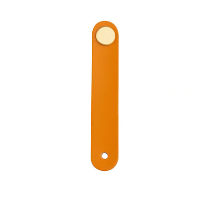 The Mantara L-0001 Maverick Pull Knob is a Nordic leather and brass knob in orange, ideal for kitchens and furniture.