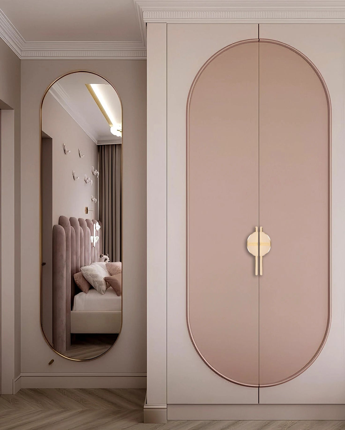 Pink wardrobe with sleek handles and mirror reflection, styled in a cozy bedroom setting with soft tones—by Mantara.