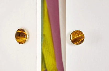 The Mantara M-0005 Pearlescent Knob is a modern brass and marble knob in tiger stone, ideal for wardrobes and cabinets.