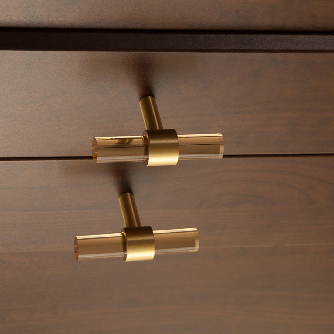 A stylish T-bar cabinet handle, Petra I made of clear acrylic and brushed brass in dark brown finish, model A-0007 by Mantara, A-0007.