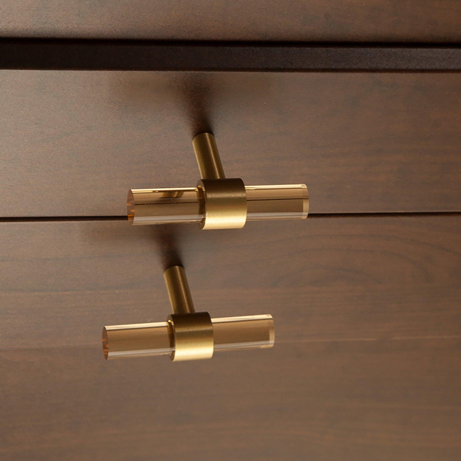 A stylish T-bar cabinet handle, Petra I made of clear acrylic and brushed brass in dark brown finish, model A-0007 by Mantara, A-0007.