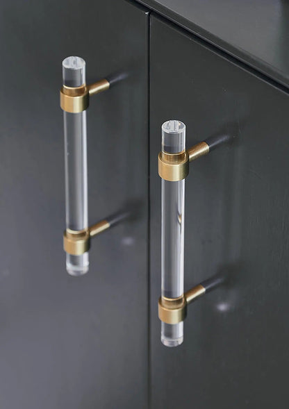 A sleek T-bar handle, Petra II made of clear acrylic with brushed brass supports in transparent white finish, model A-0008 by Mantara, A-0008.