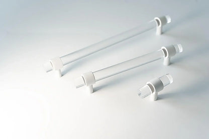 A sleek bar handle, Petra III made of acrylic with polished brass mounts in white finish, model A-0009 by Mantara, SKU A-0009.