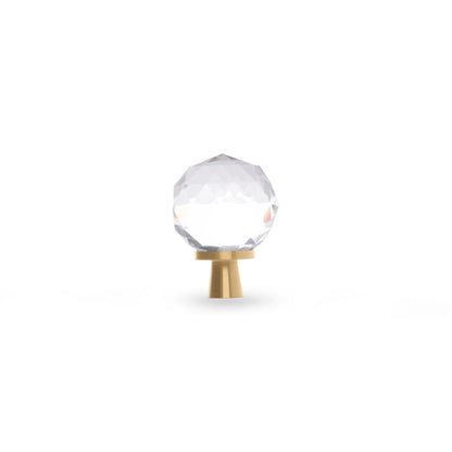 The Mantara C-0016 Quartz Handle is a modern crystal knob in white with polished brass, ideal for wardrobes, cabinets, and kitchens.