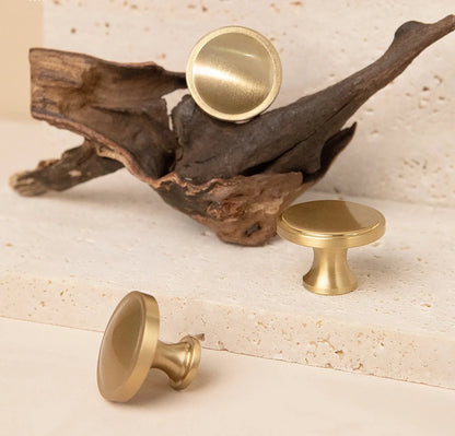 The Mantara B-0007 Regina Knob is a modern satin brass knob in gold and bronze, perfect for kitchens, cabinets, drawers, and wardrobes.