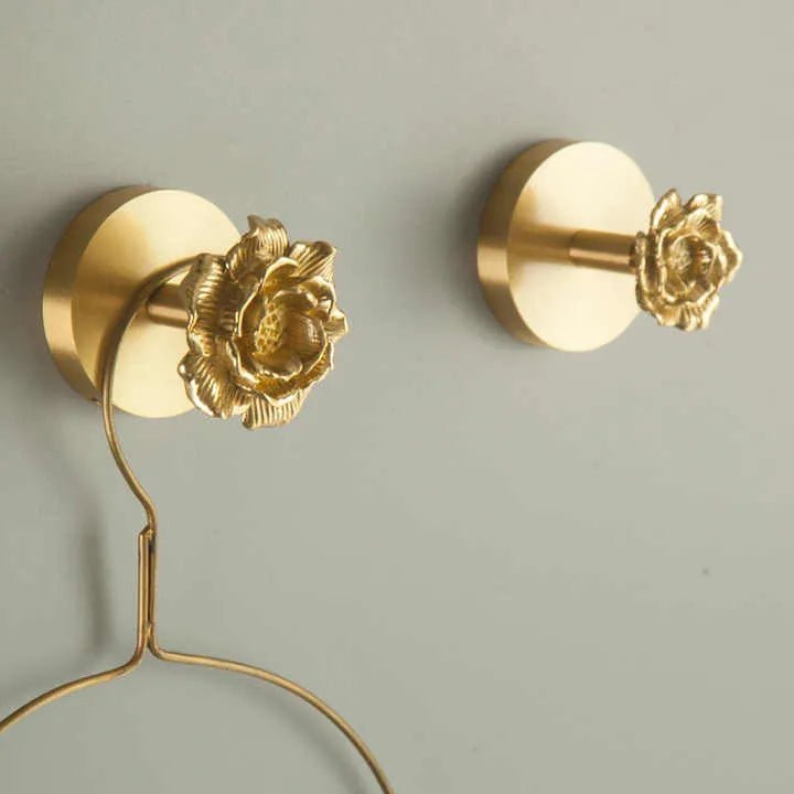 The Rosalia Hook by Mantara B-0117 is a modern brass wall hook in gold with a brushed finish, perfect for kitchens and dressers.