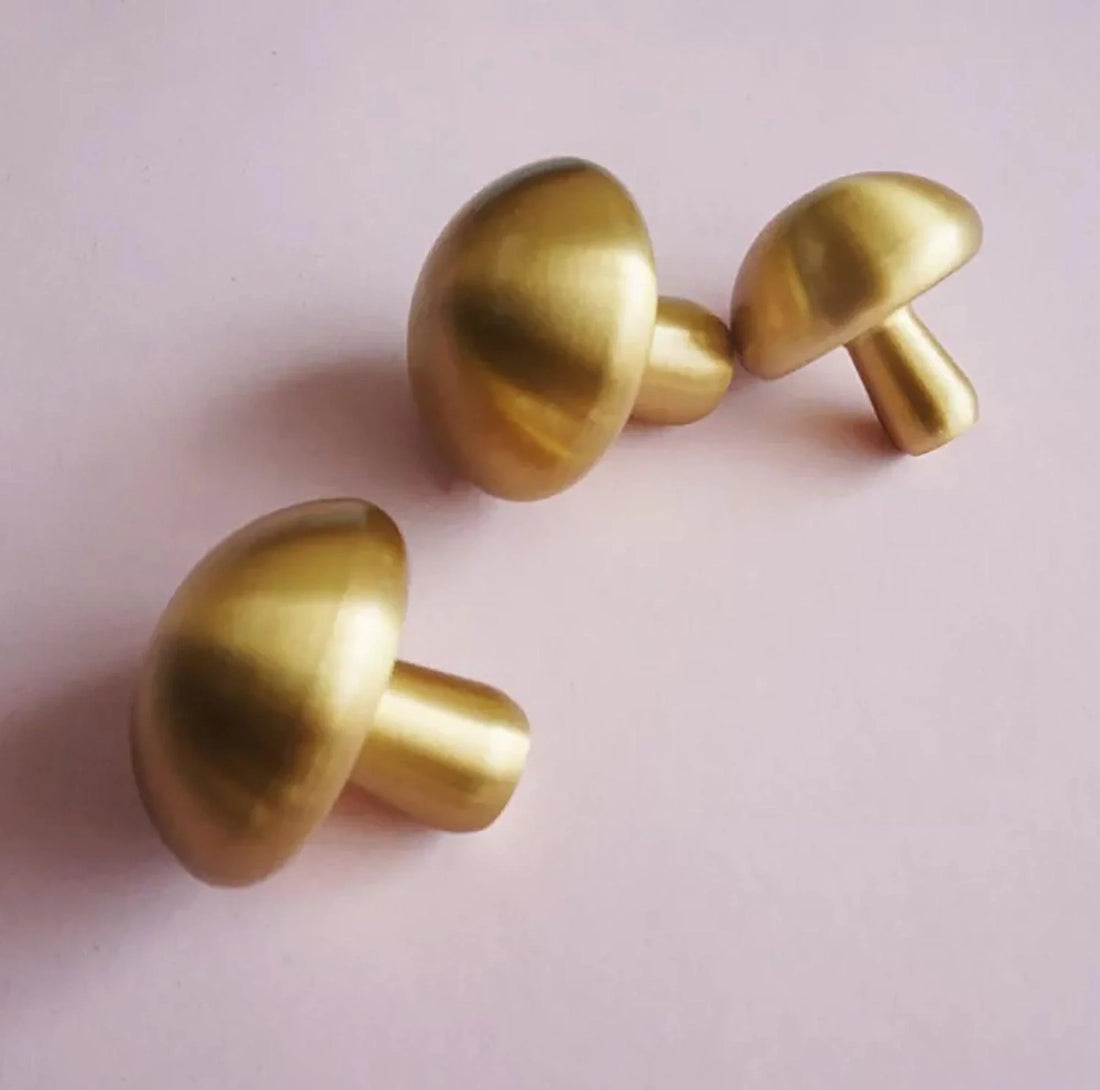 Mantara Shroom Knob B-0100 is a modern solid brass knob in brushed gold, perfect for kitchens, cabinets, and furniture.
