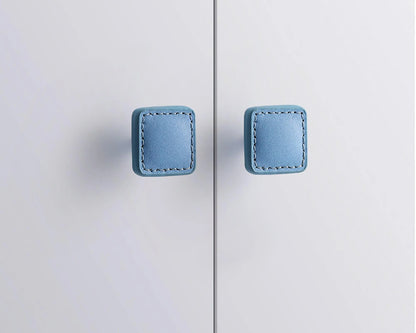 The Mantara L-0008 Sofia Square Knob is a modern leather knob in blue, perfect for cabinets and drawers.