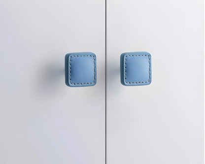 The Mantara L-0008 Sofia Square Knob is a modern leather knob in blue, perfect for cabinets and drawers.