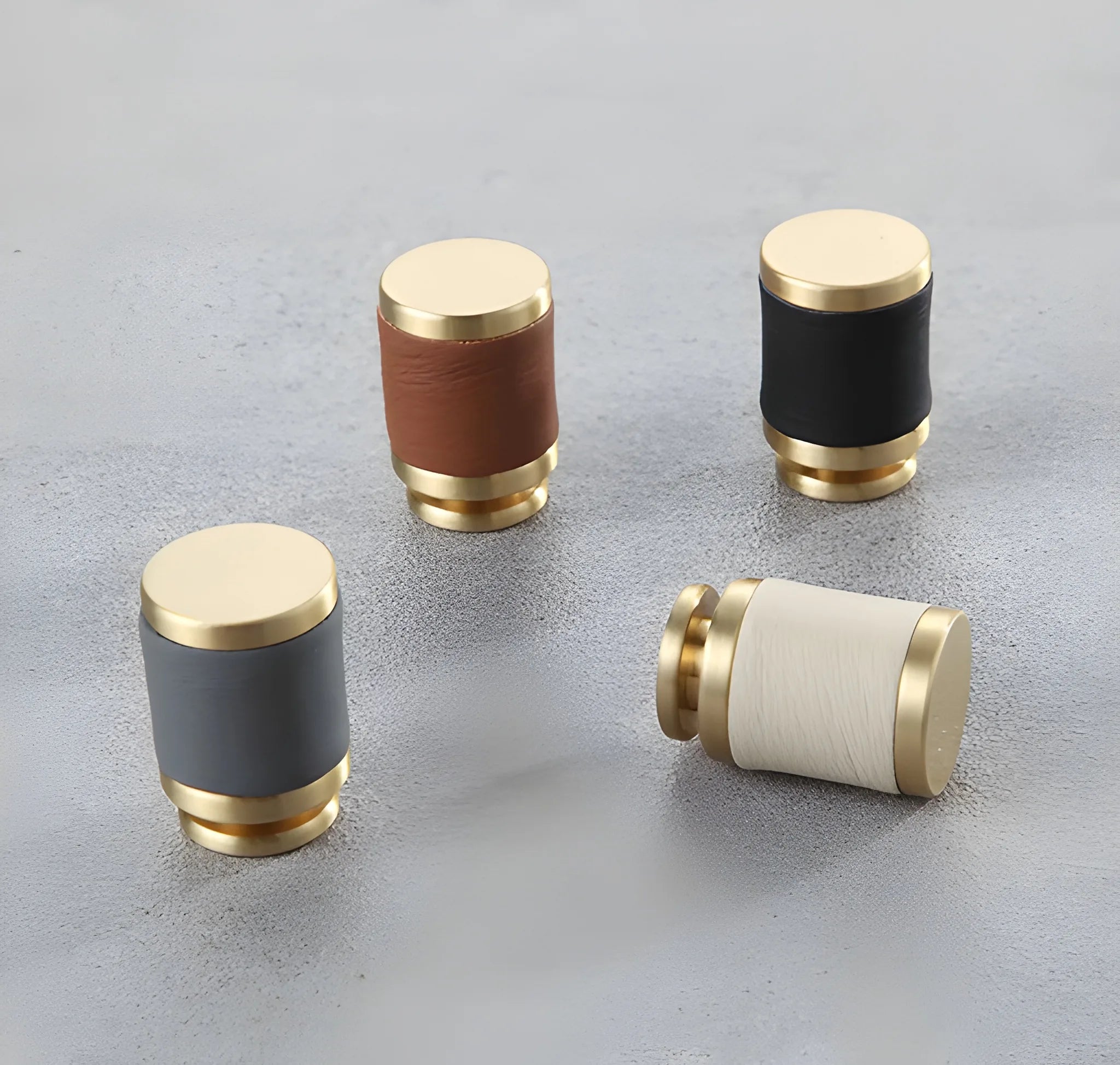 The Mantara L-0003 Tanner Knob is a modern brass and leather knob in white, black, brown, and grey, perfect for cabinets and furniture.