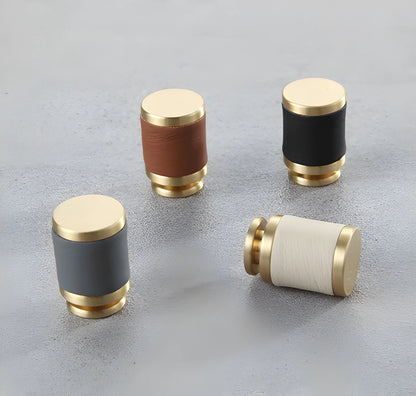 The Mantara L-0003 Tanner Knob is a modern brass and leather knob in white, black, brown, and grey, perfect for cabinets and furniture.