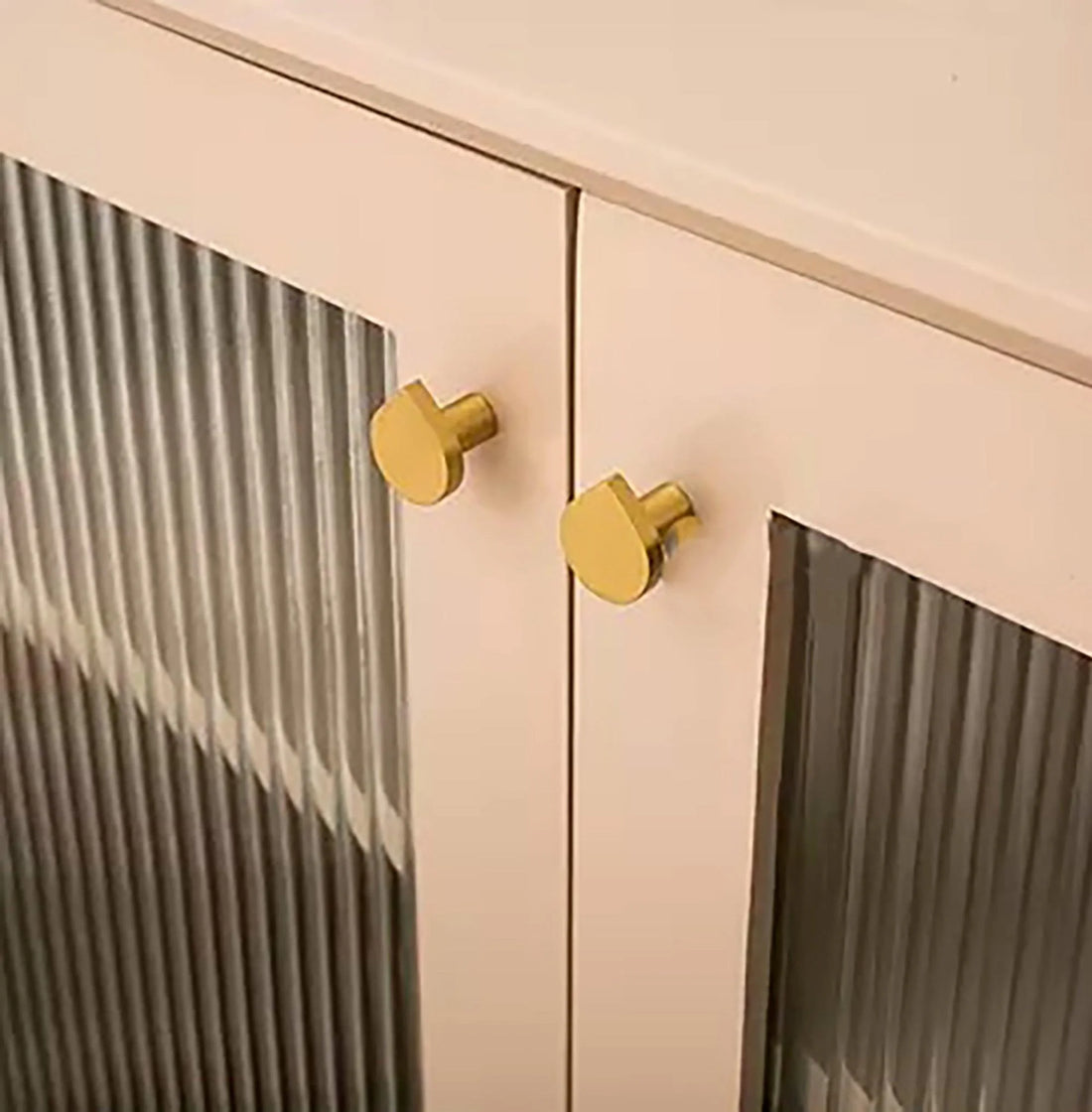 The Tarang Knob by Mantara (B-0104) is a brushed brass modern pair knob in gold, perfect for wardrobes, doors, and kitchens.