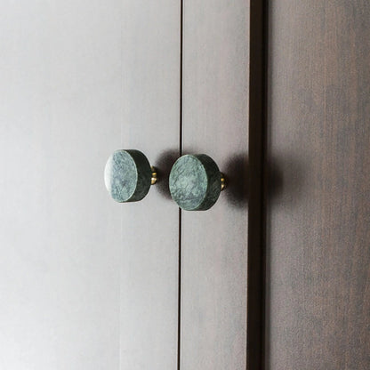 The Mantara M-0001 Theo Knob is a modern marble and brass knob in green, ideal for doors, drawers, and cabinets.