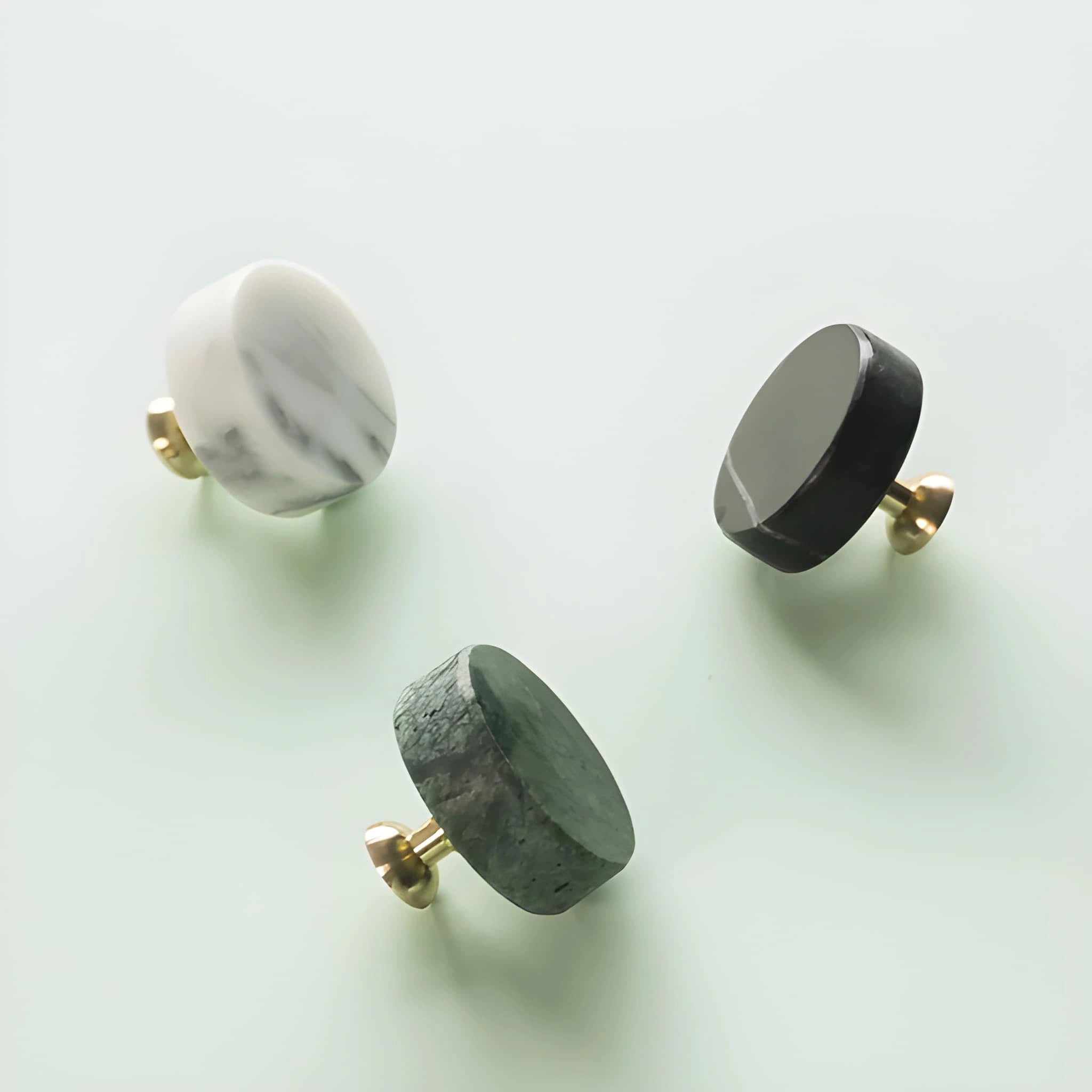 The Mantara M-0001 Theo Knob is a modern marble and brass knob in Grey, ideal for doors, drawers, and cabinets.