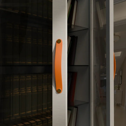 The Mantara L-0001-160 Maverick Handle is a Nordic leather and brass handle in orange, ideal for kitchens and wardrobes.