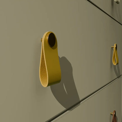 The Mantara L-0001 Maverick Pull Knob is a Nordic leather and brass knob in yellow, ideal for kitchens and furniture.