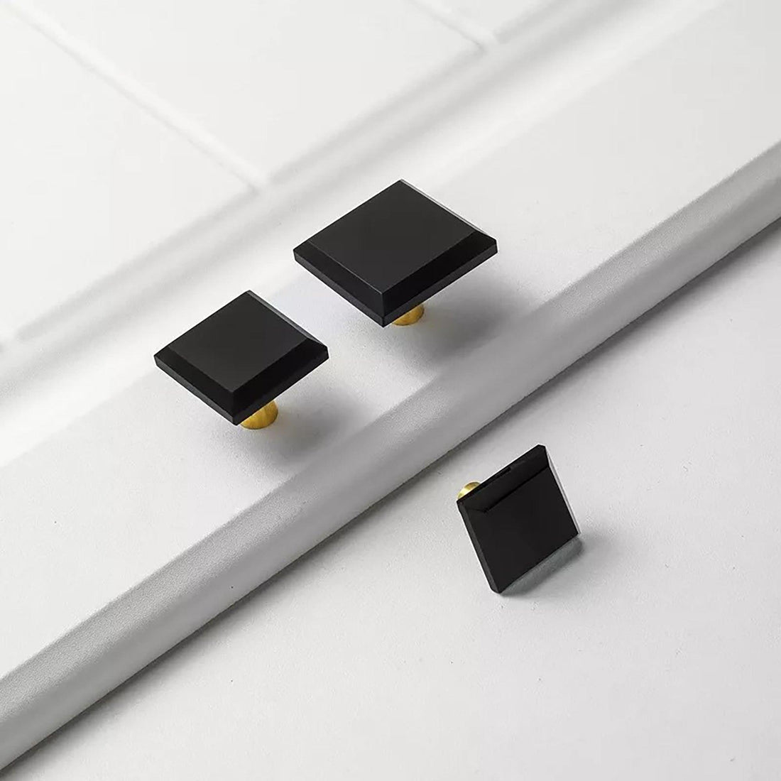 A contemporary drawer knob made of durable brass and acrylic in polished black finish, model A-0013 by Mantara, SKU A-0013.