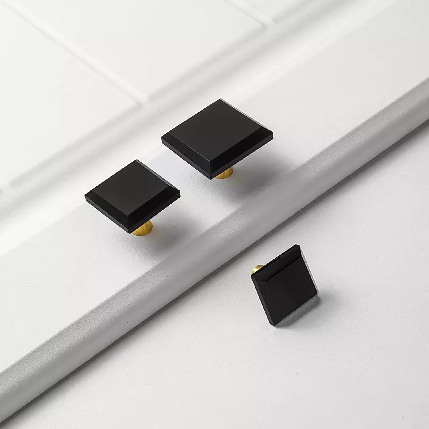 A contemporary drawer knob made of durable brass and acrylic in polished black finish, model A-0013 by Mantara, SKU A-0013.