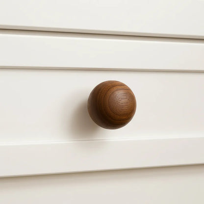 Dark Wooden knob on a white drawer
