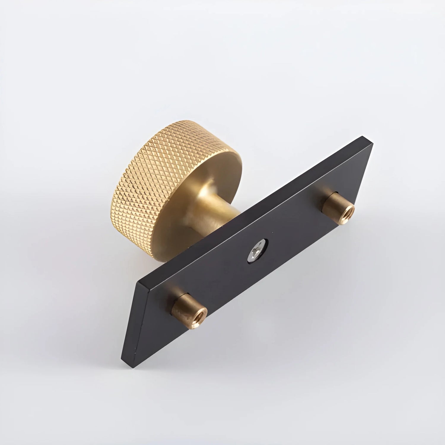 The Mantara B-0118 is a modern brass knob in gold with a black stabiliser base, ideal for kitchen and dresser drawers.
