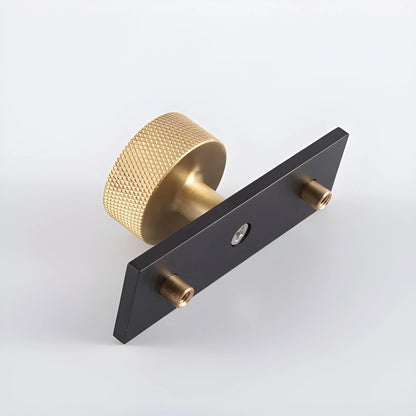 The Mantara B-0118 is a modern brass knob in gold with a black stabiliser base, ideal for kitchen and dresser drawers.
