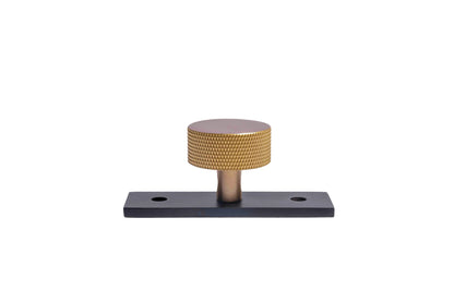 The Mantara B-0118 is a modern brass knob in gold with a black stabiliser base, ideal for kitchen and dresser drawers.